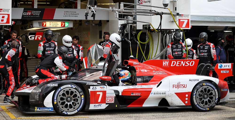 TOYOTA GAZOO Racing team checking the machine in the pit, Le Mans, 2022.
